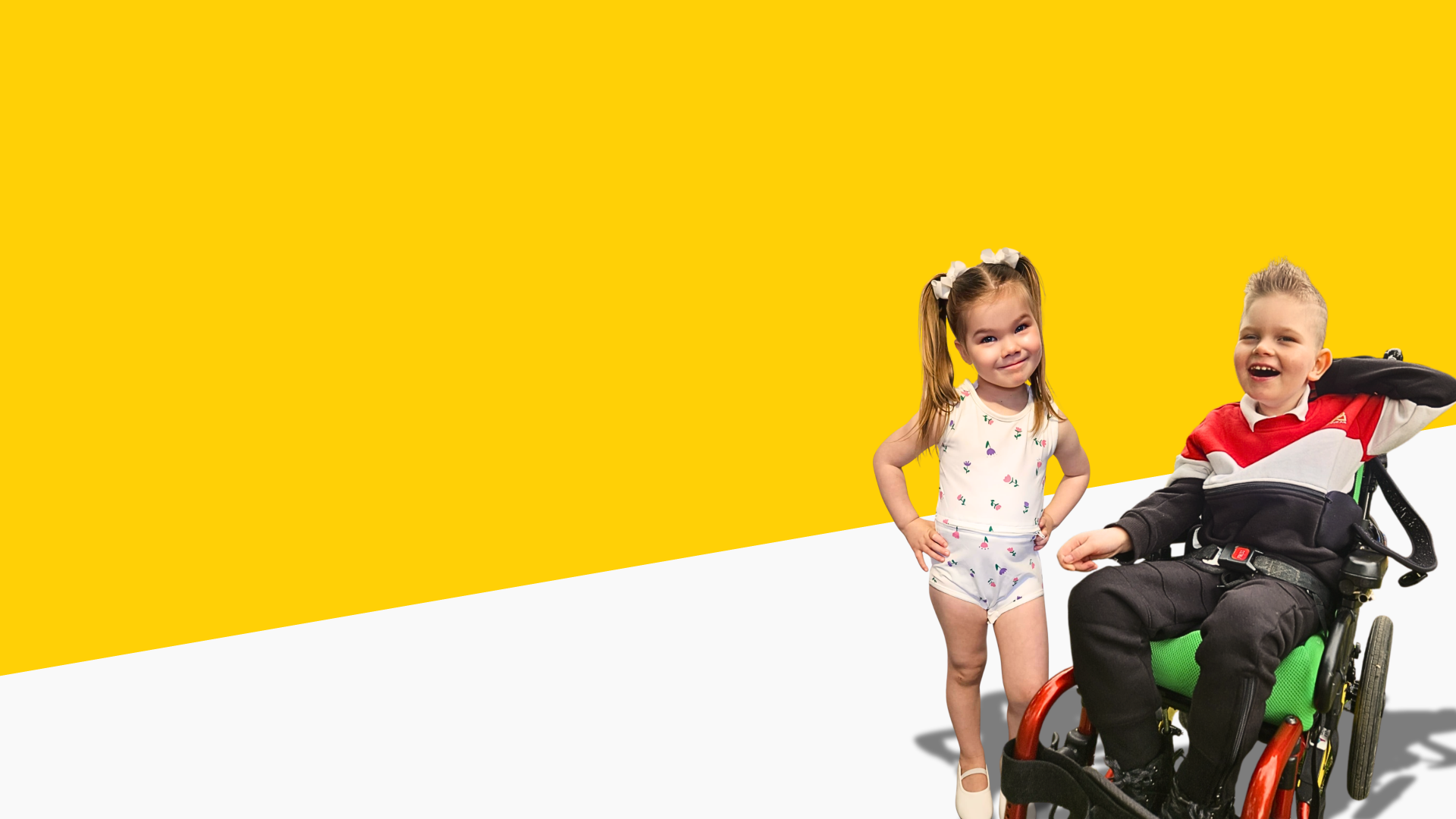 Two children, one in a wheelchair, standing against a yellow background