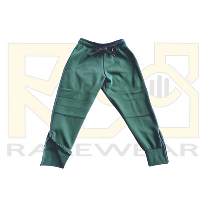 A pair of green OrthoEase Adaptive TrackPants for kids, featuring an elastic waistband with drawstring, double knee design, and ankle zips.