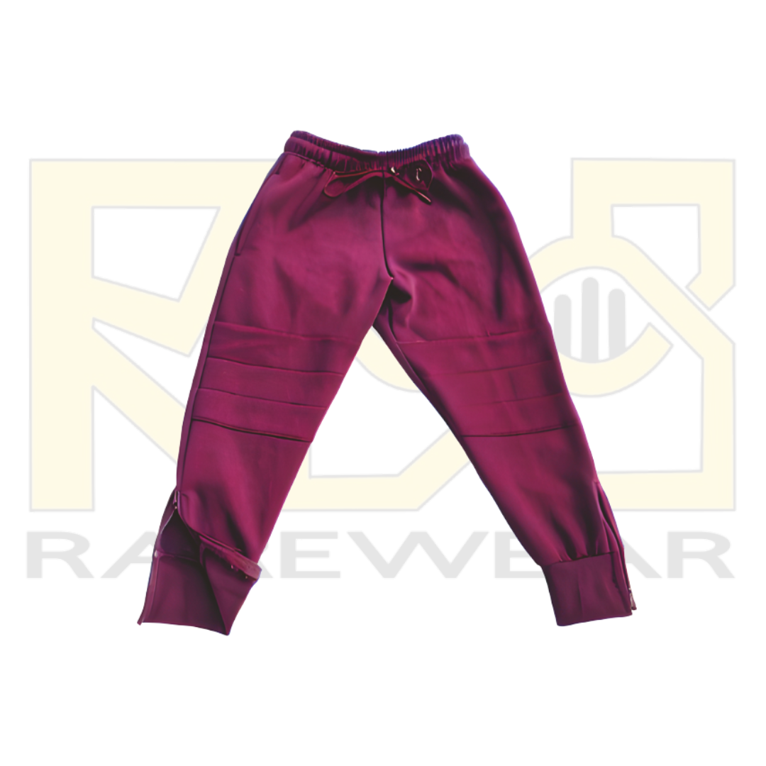 A pair of maroon OrthoEase Adaptive TrackPants for kids, featuring an elastic waistband with drawstring, double knee design, and ankle zips.