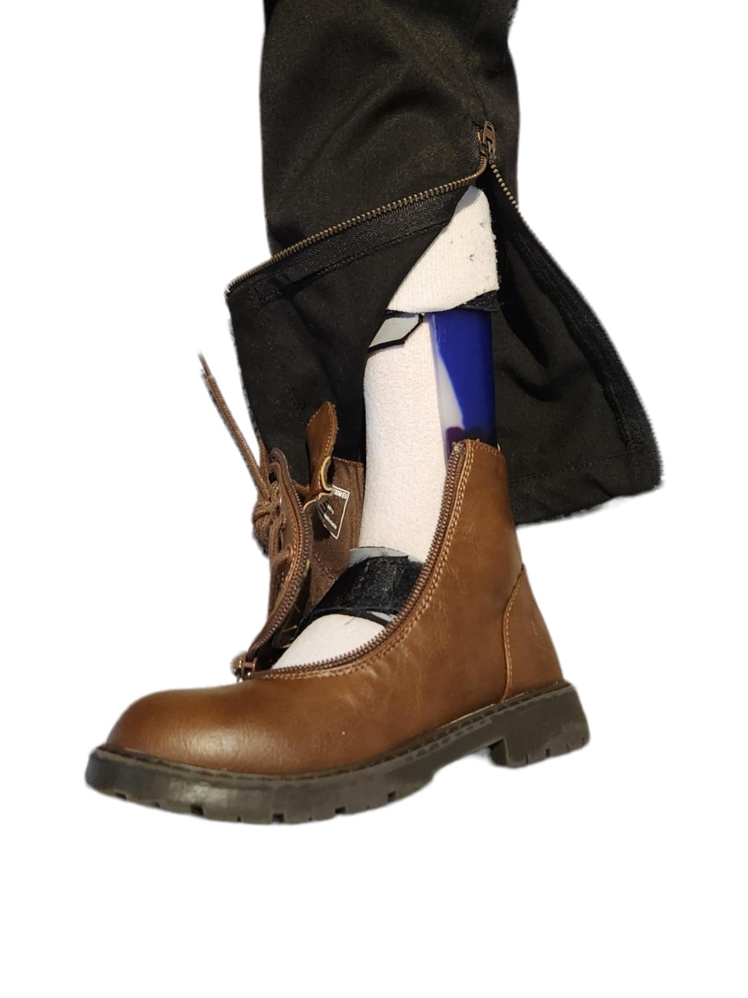 Section of Lloyd black trouser opened by zip access at ankle with ankle foot orthotic, adaptive brown boot and white socks